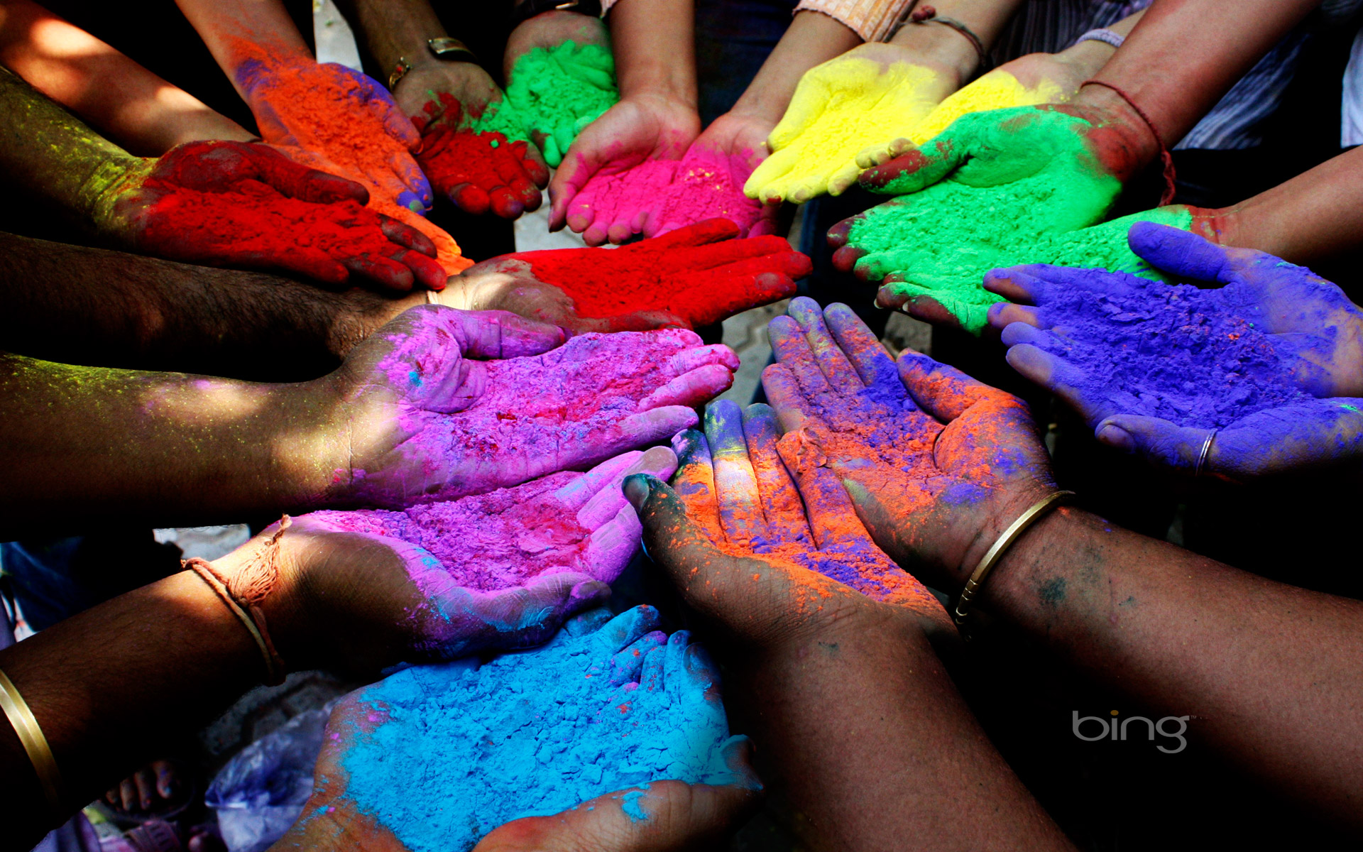 People holding powder paints to celebrate Holi (Festival of Colors) in Ahmedabad, India